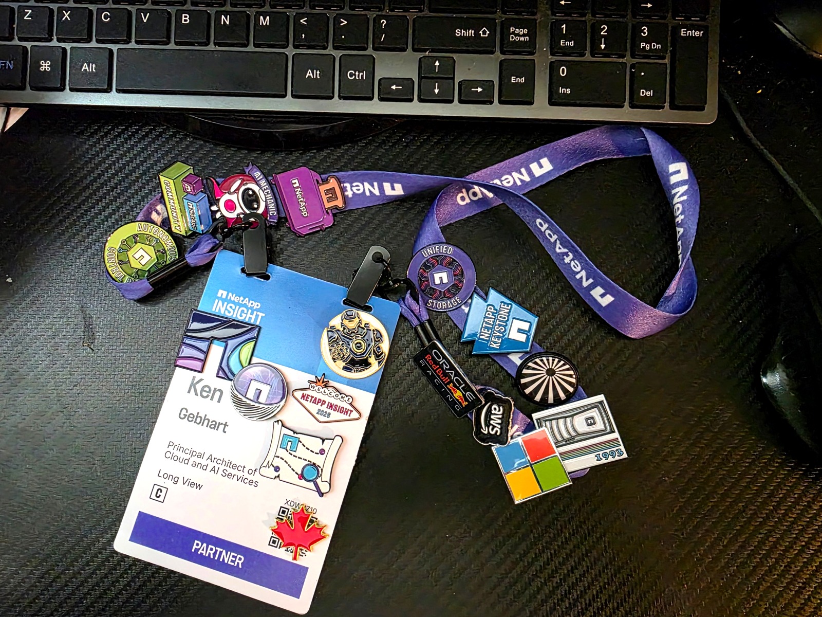 NetApp INSIGHT 2026 badge and lanyard pins from the week.